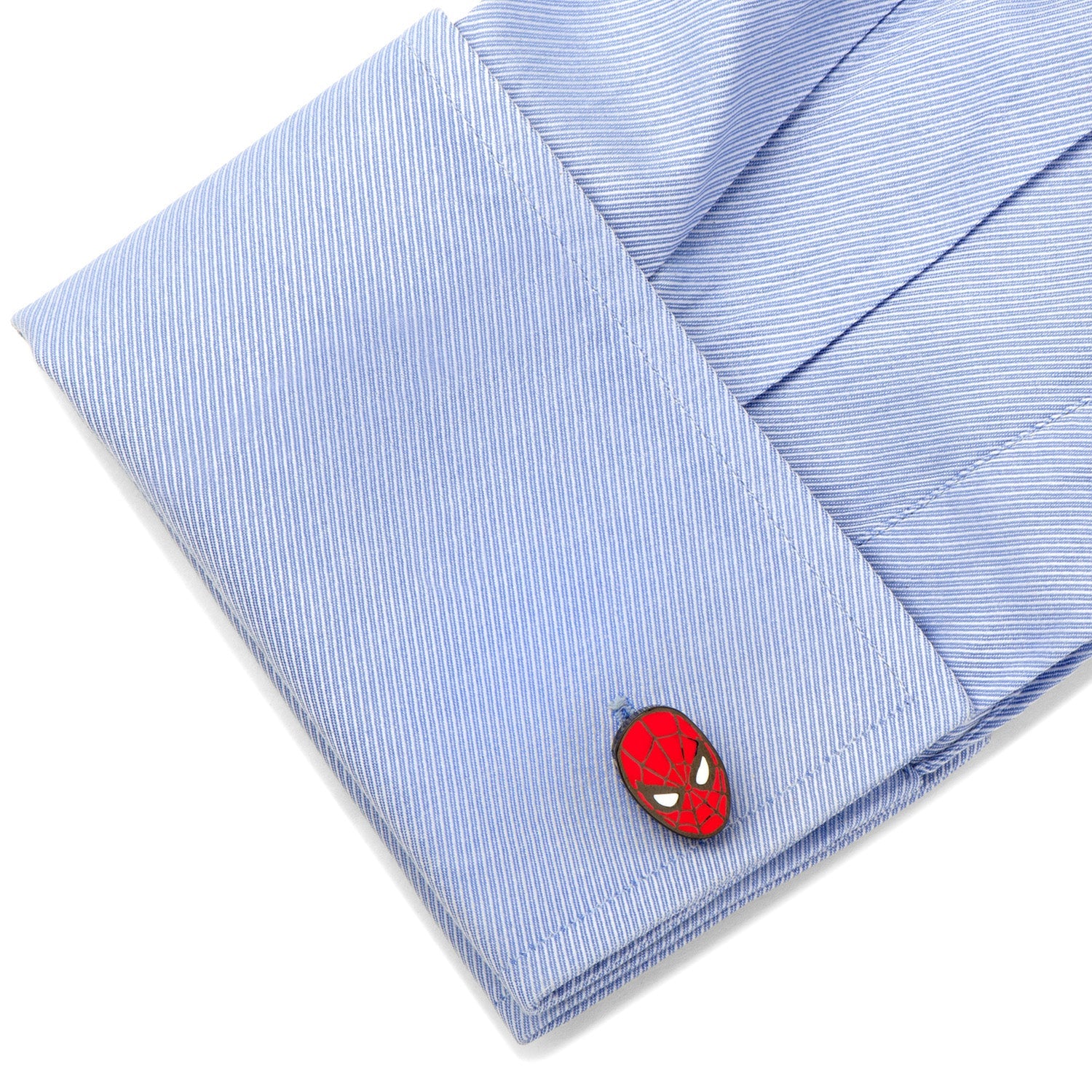 Close-up of a blue striped shirt with a Spider-Man themed cufflink.