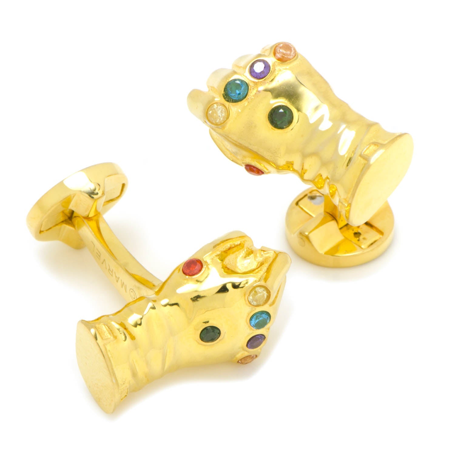 Gold cufflinks shaped like a gauntlet with colored stones on a white background