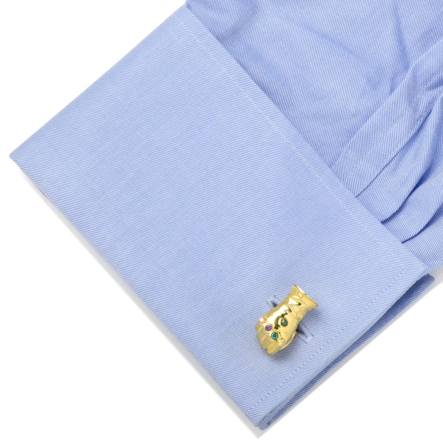Gold cufflink on a blue shirt sleeve