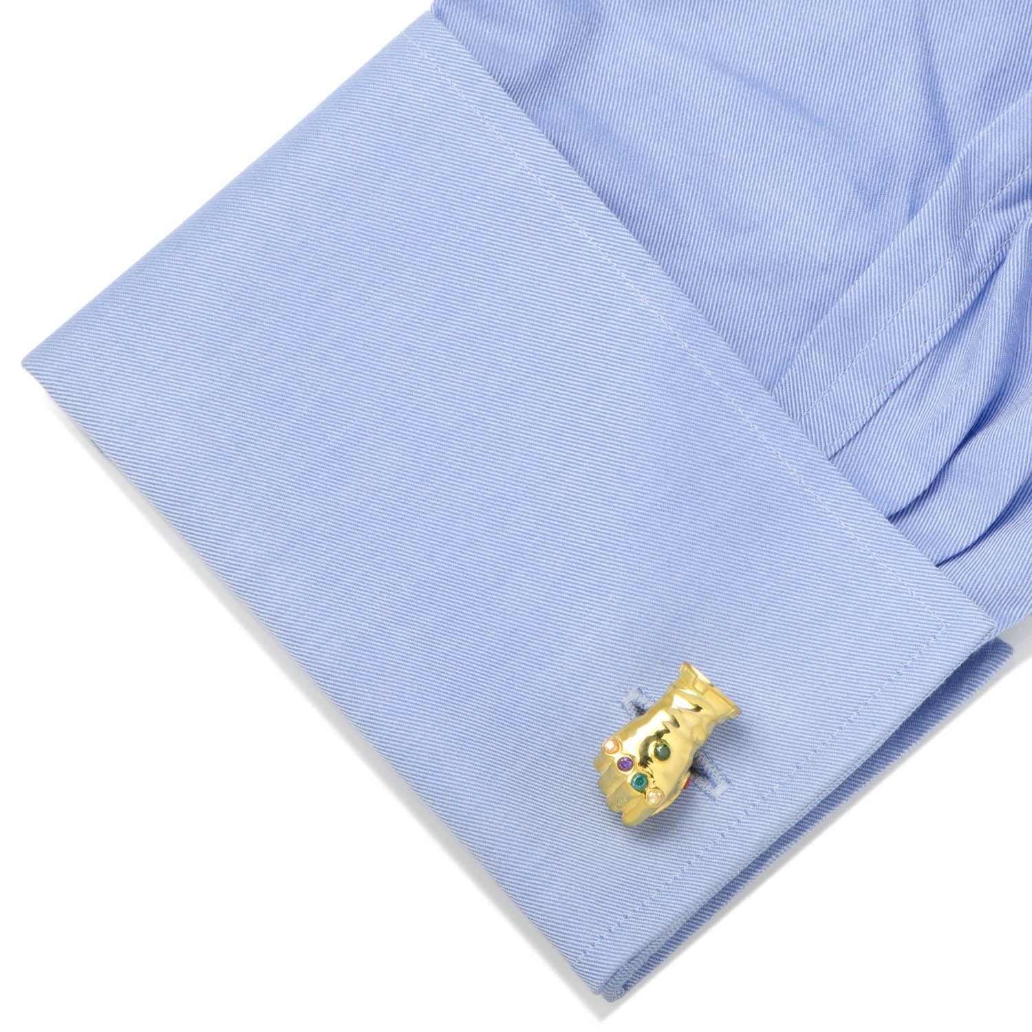 Gold cufflink on a blue shirt sleeve