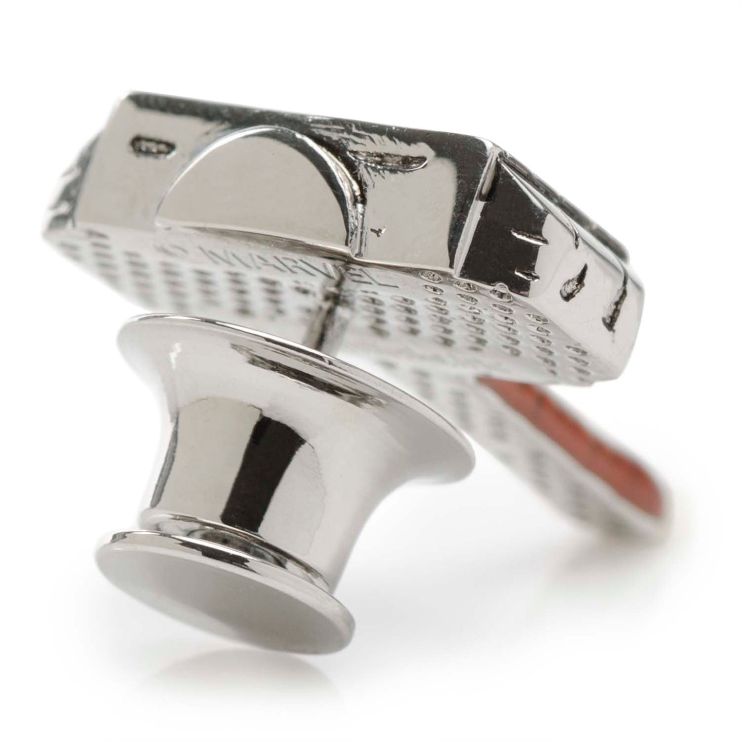 Close-up of a metallic valve stem cap on a white background