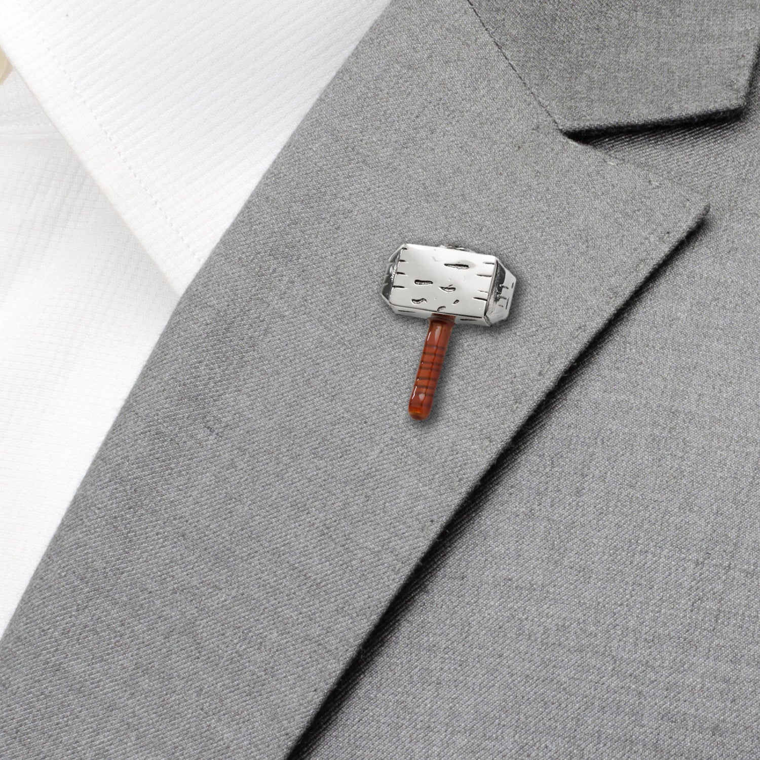 Thor's hammer pin on a gray suit jacket
