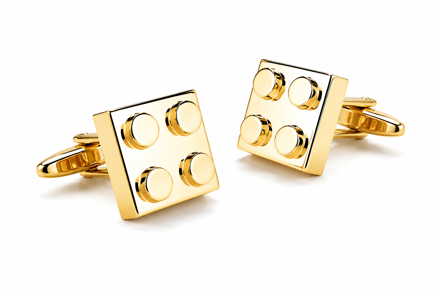 Close-up view of gold building block cufflinks with polished square design and bullet back closure
