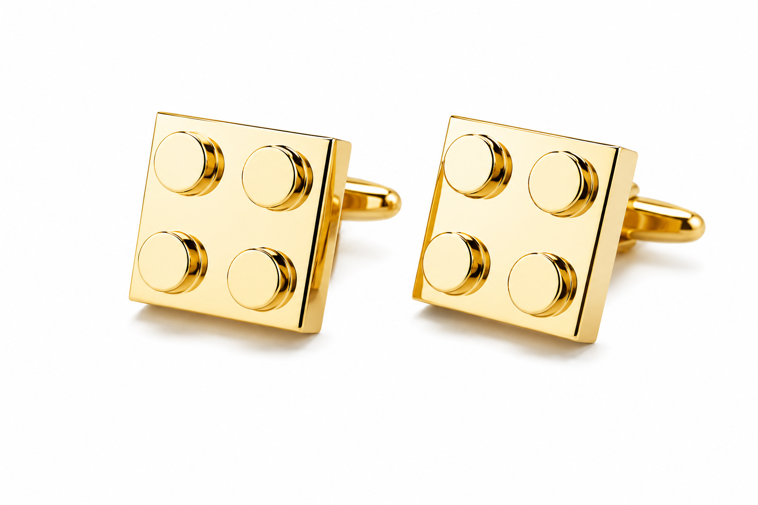 Gold building block cufflinks on a white background