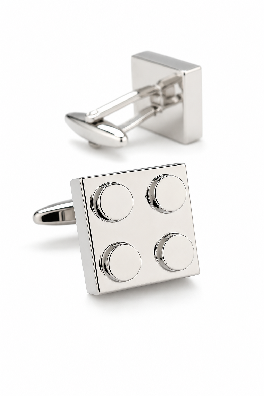 Silver cufflinks with a block design on a white background