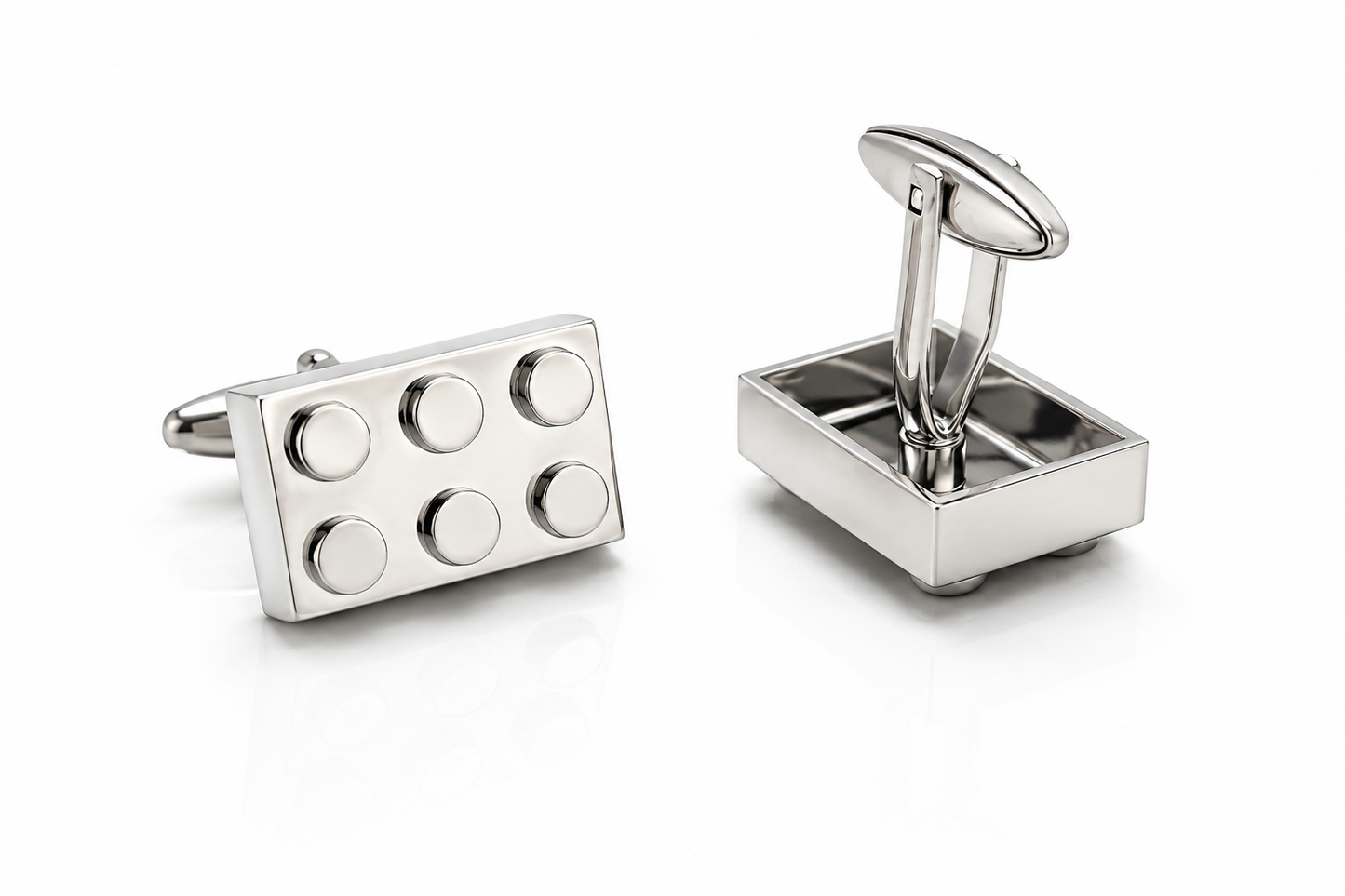Silver cufflinks with geometric design on a white background