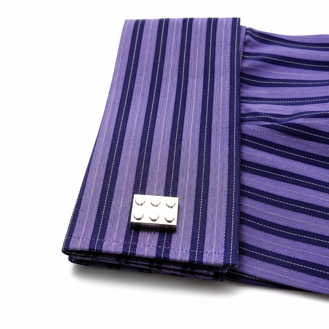 Purple striped fabric with a silver Lego piece on a white background