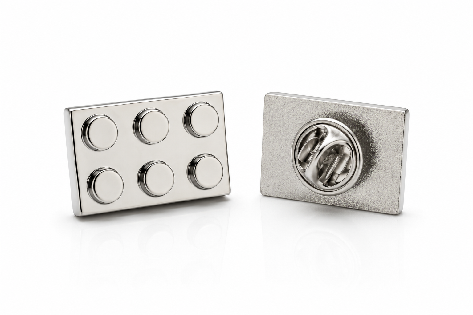 Silver building block lapel pin with six raised studs and butterfly clutch backing on white background