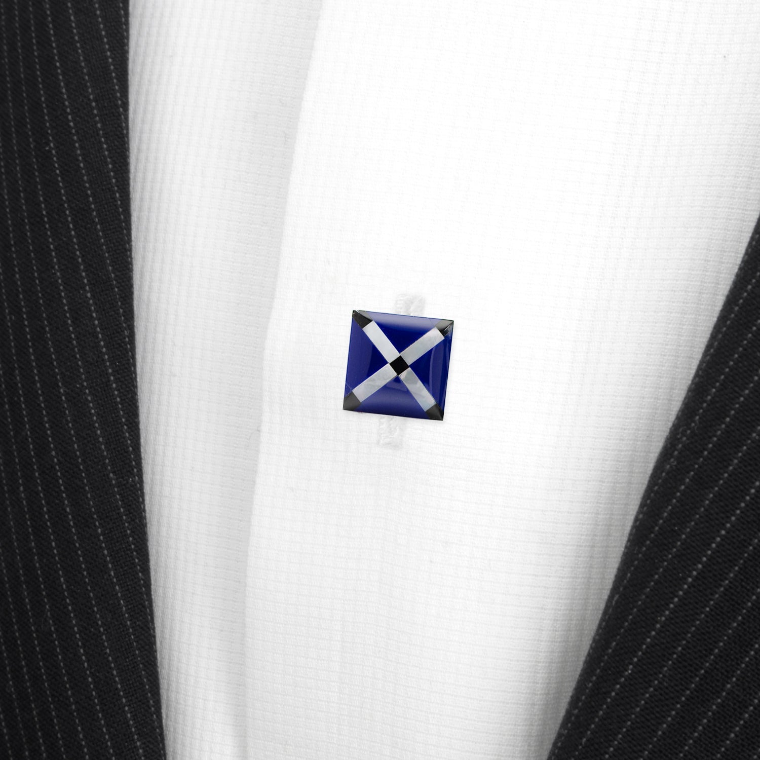 Cufflinks with a blue and white design on a suit jacket
