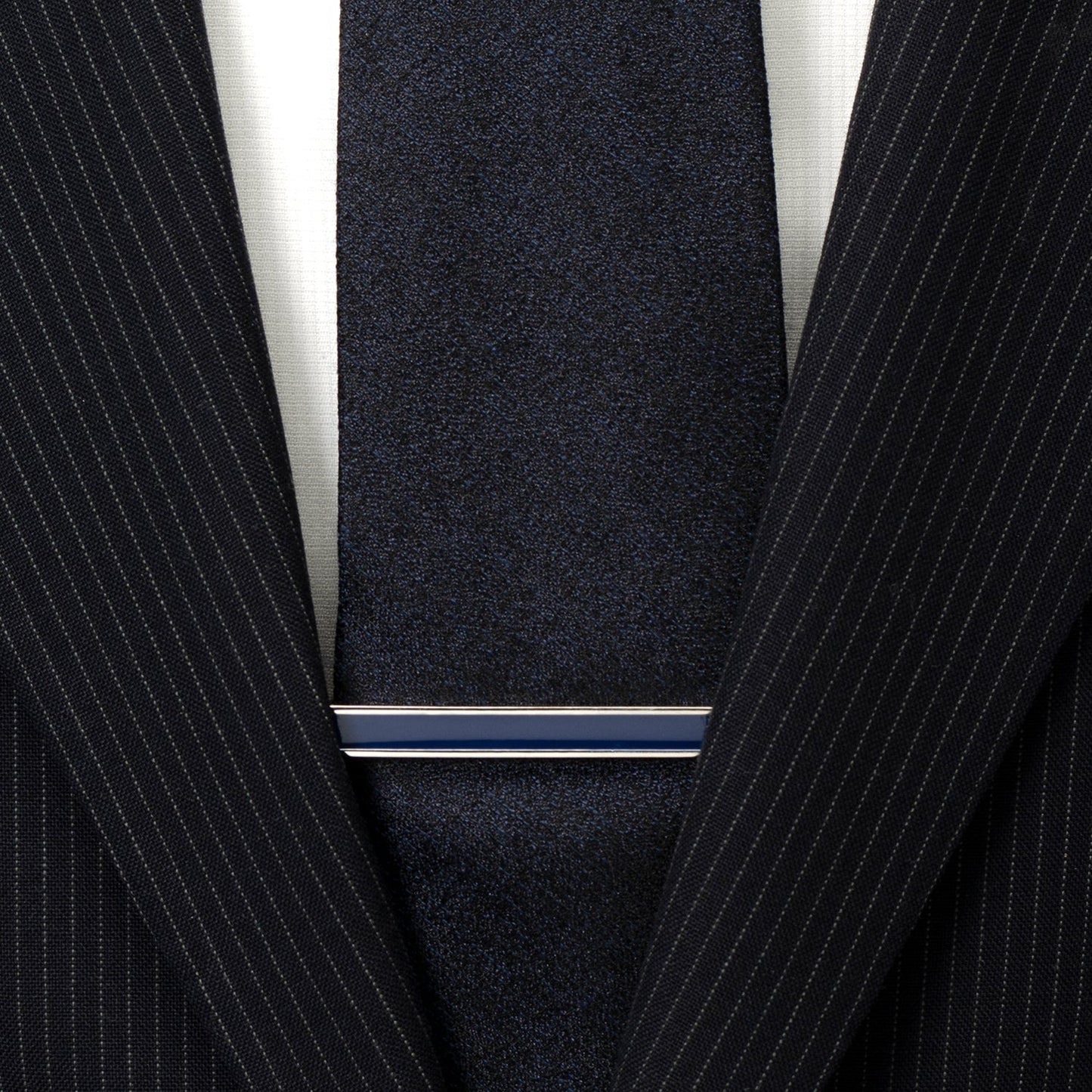Close-up of a navy pinstripe suit with a tie and white shirt