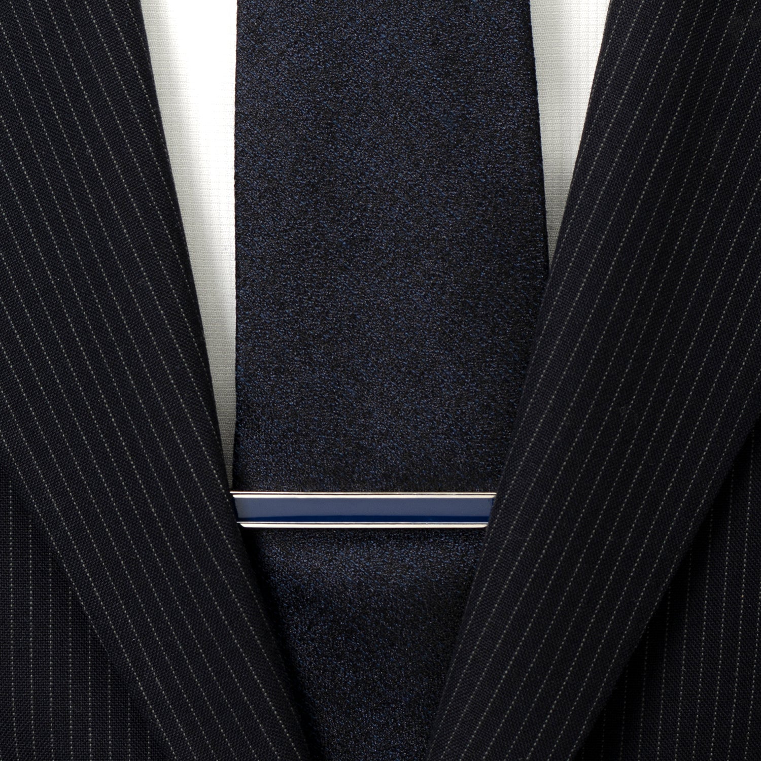 Close-up of a navy pinstripe suit with a tie and white shirt