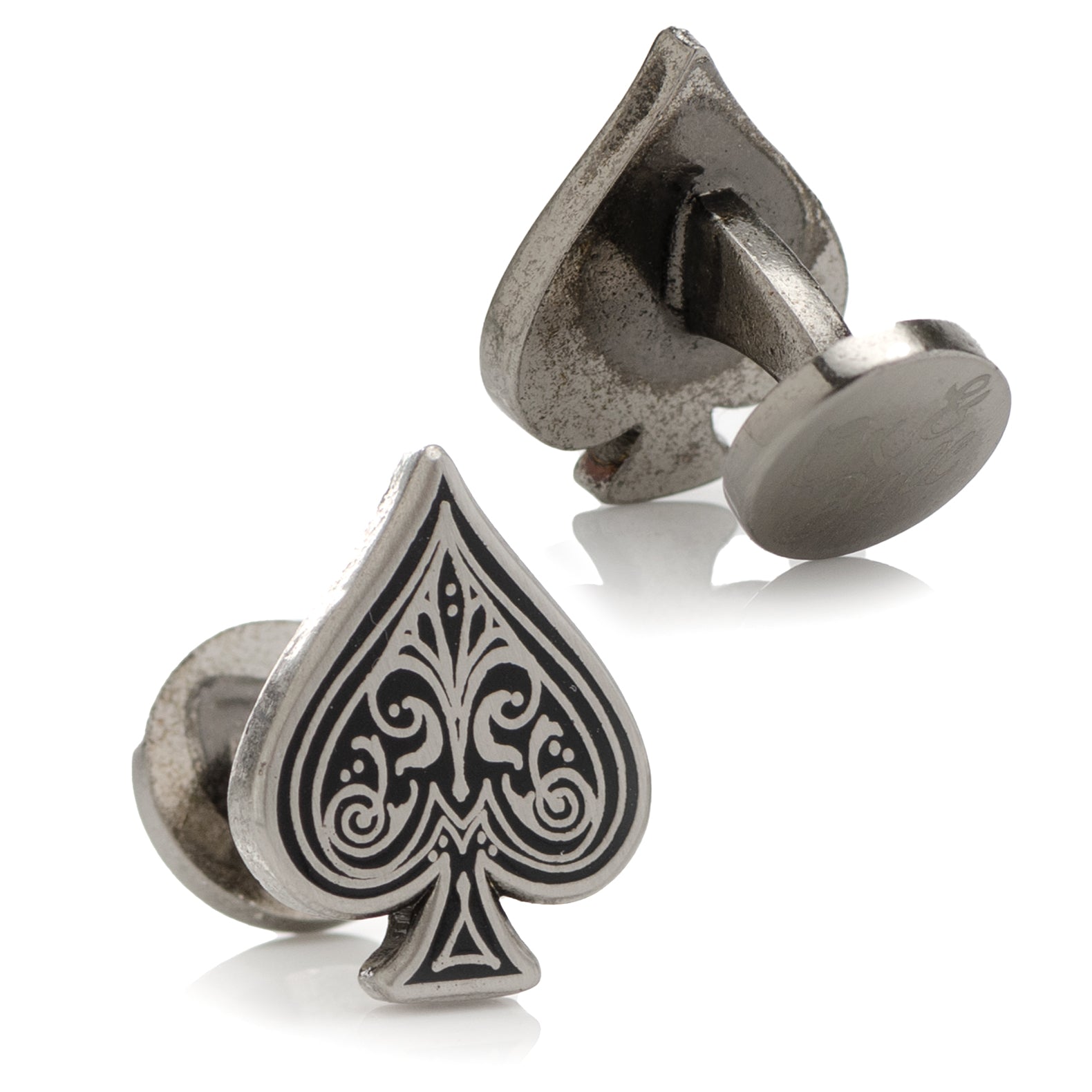 Silver cufflinks with a detailed spade design on a white background