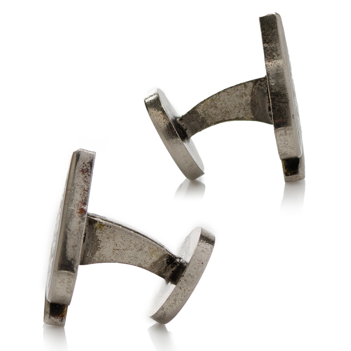 Pair of silver cufflinks on a white background