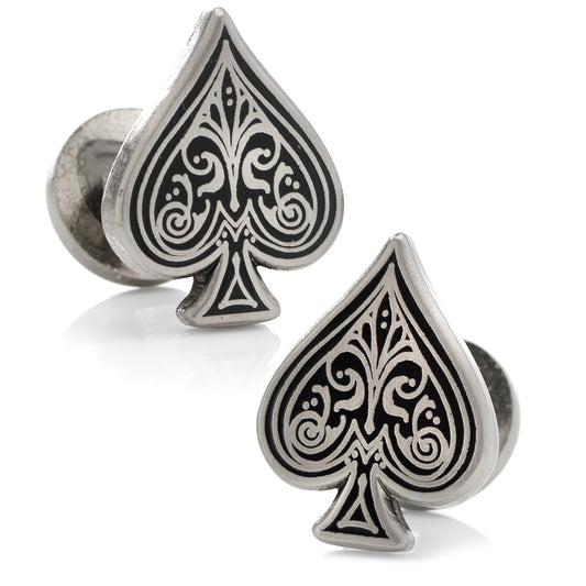 Silver cufflinks with black spade design on a white background