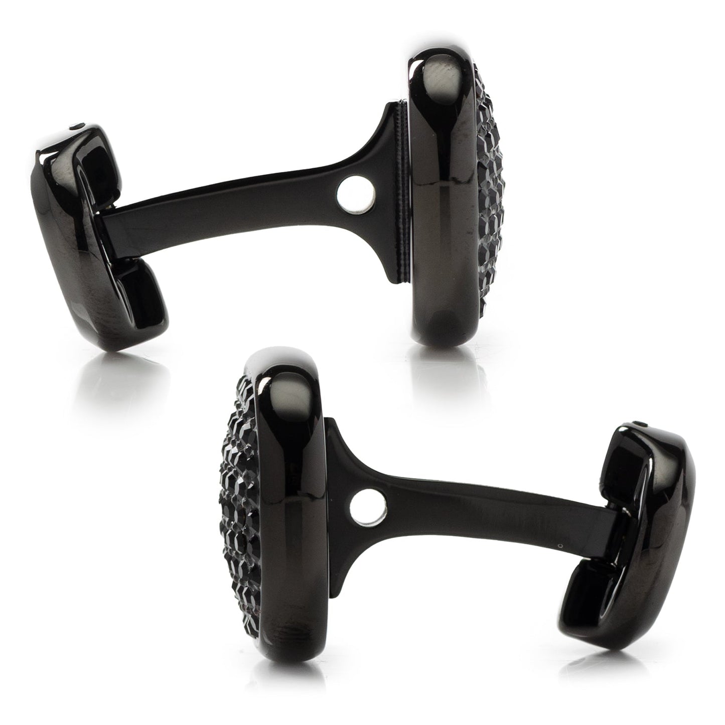 Black cufflinks with detailed design on a white background