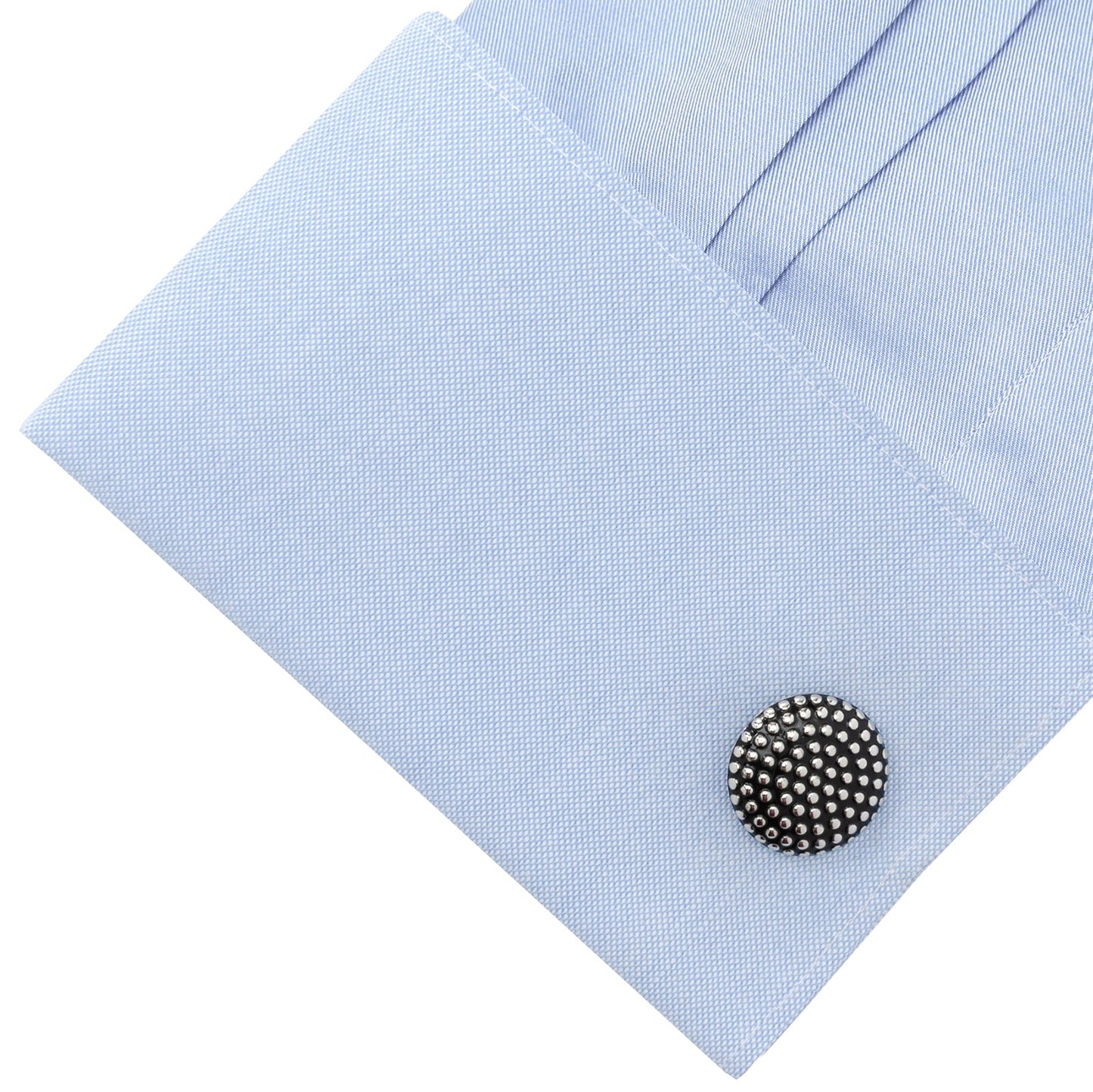 Cufflink on a light blue dress shirt