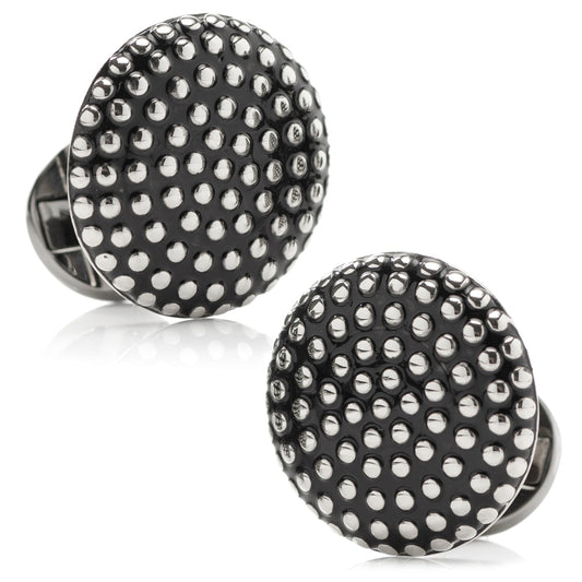 Black cufflinks with silver studs on a white background