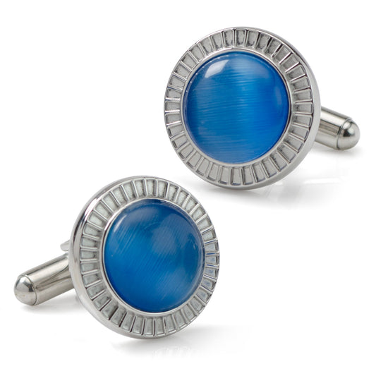 Pair of blue cufflinks with silver rims on a white background