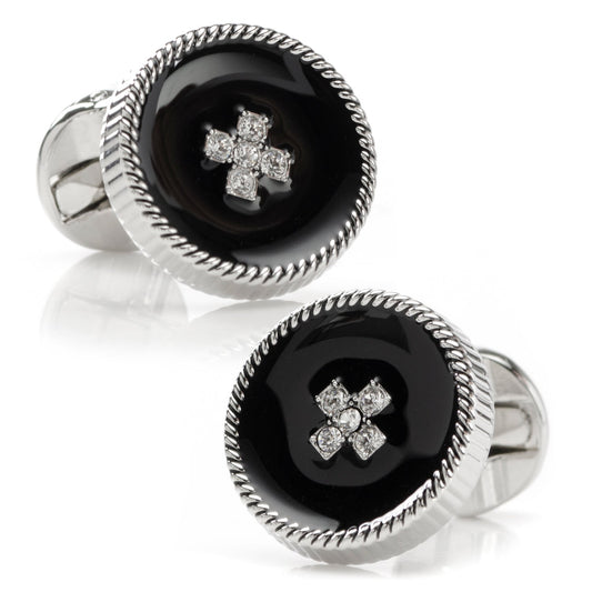 Pair of cufflinks with black center and silver cross design on a white background