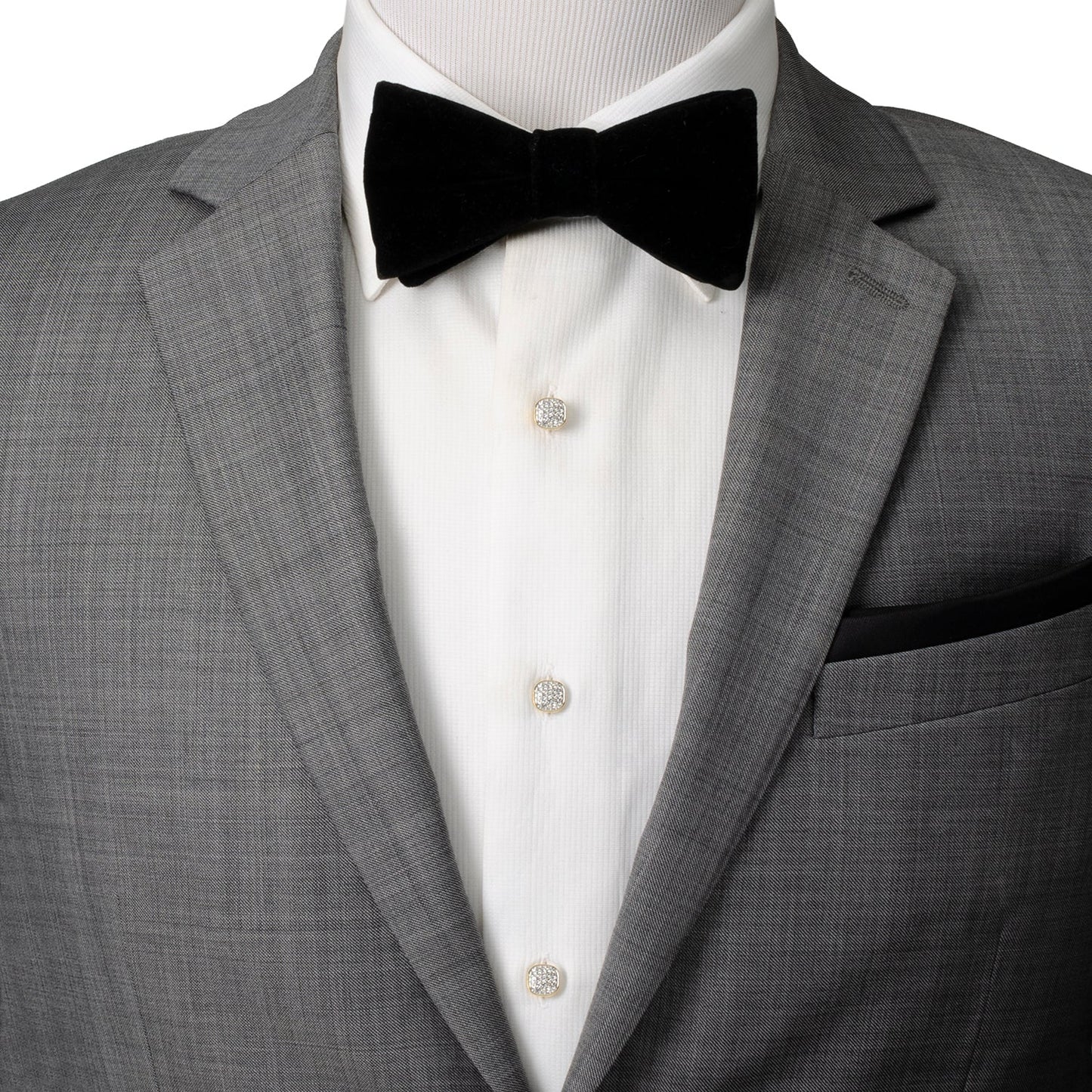 Gray suit jacket with a black bow tie and white shirt on a mannequin.