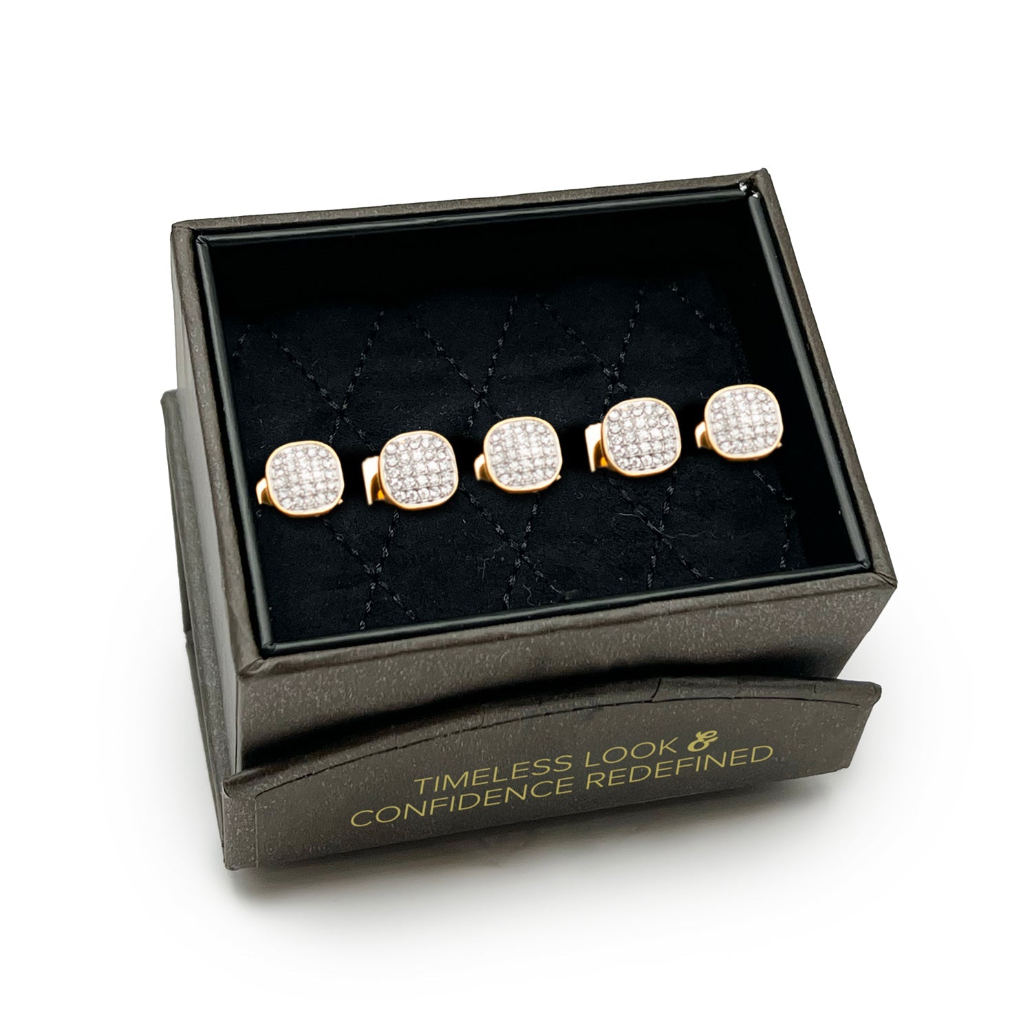 Set of gold and diamond stud earrings in a black jewelry box with text.