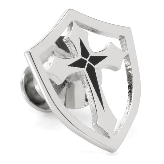 Silver-colored metal badge with a central black star design on a white background