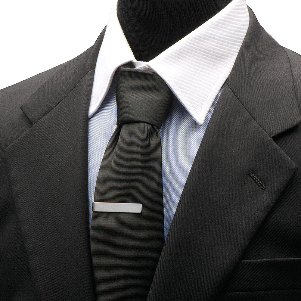Black suit with a white shirt and black tie on a mannequin
