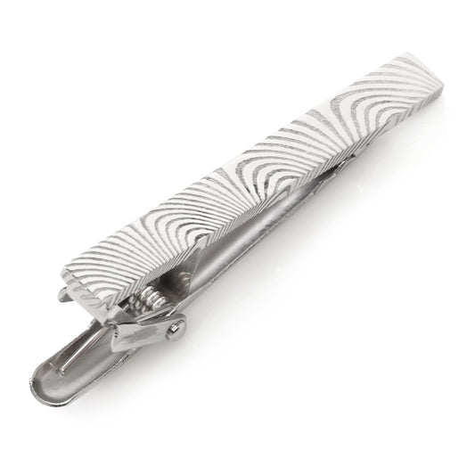 Silver tie clip with wavy pattern on a white background