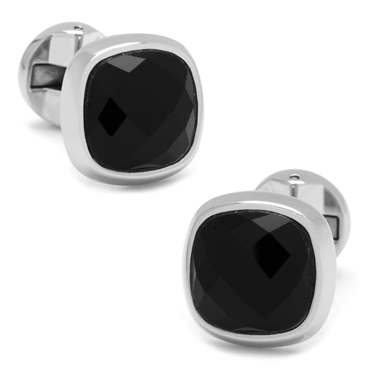 Pair of black gemstone cufflinks with silver metal frames on a white background
