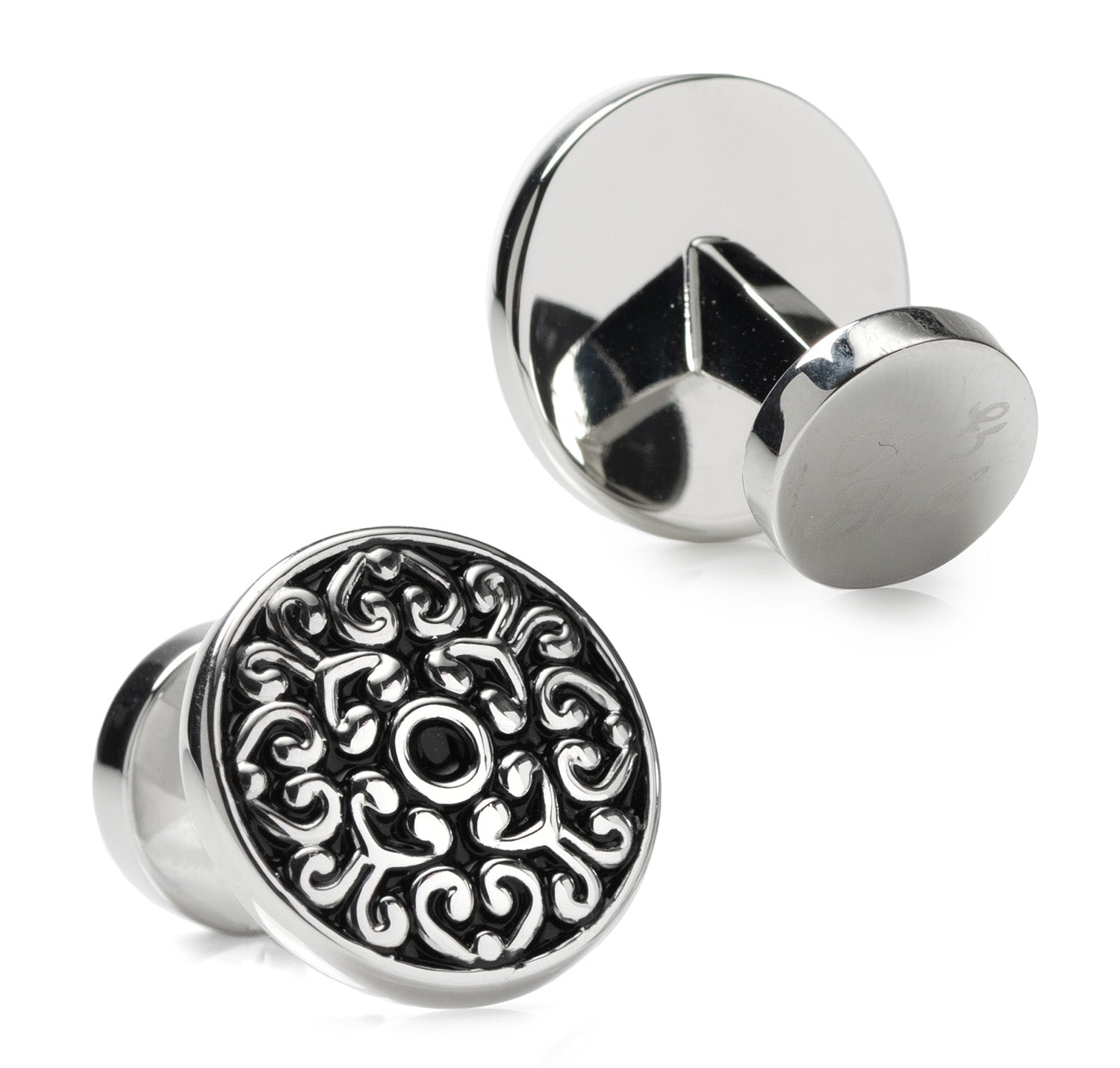 Silver cufflinks with intricate design on a white background