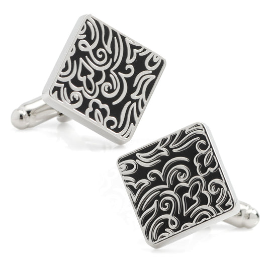 Pair of black and silver patterned cufflinks on a white background