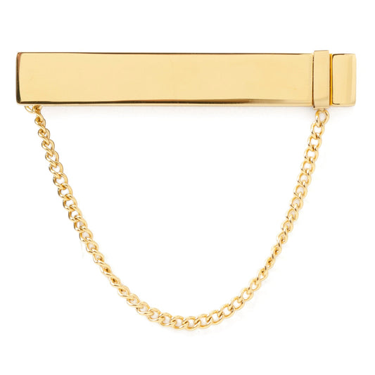 Gold tie clip with chain on a white background