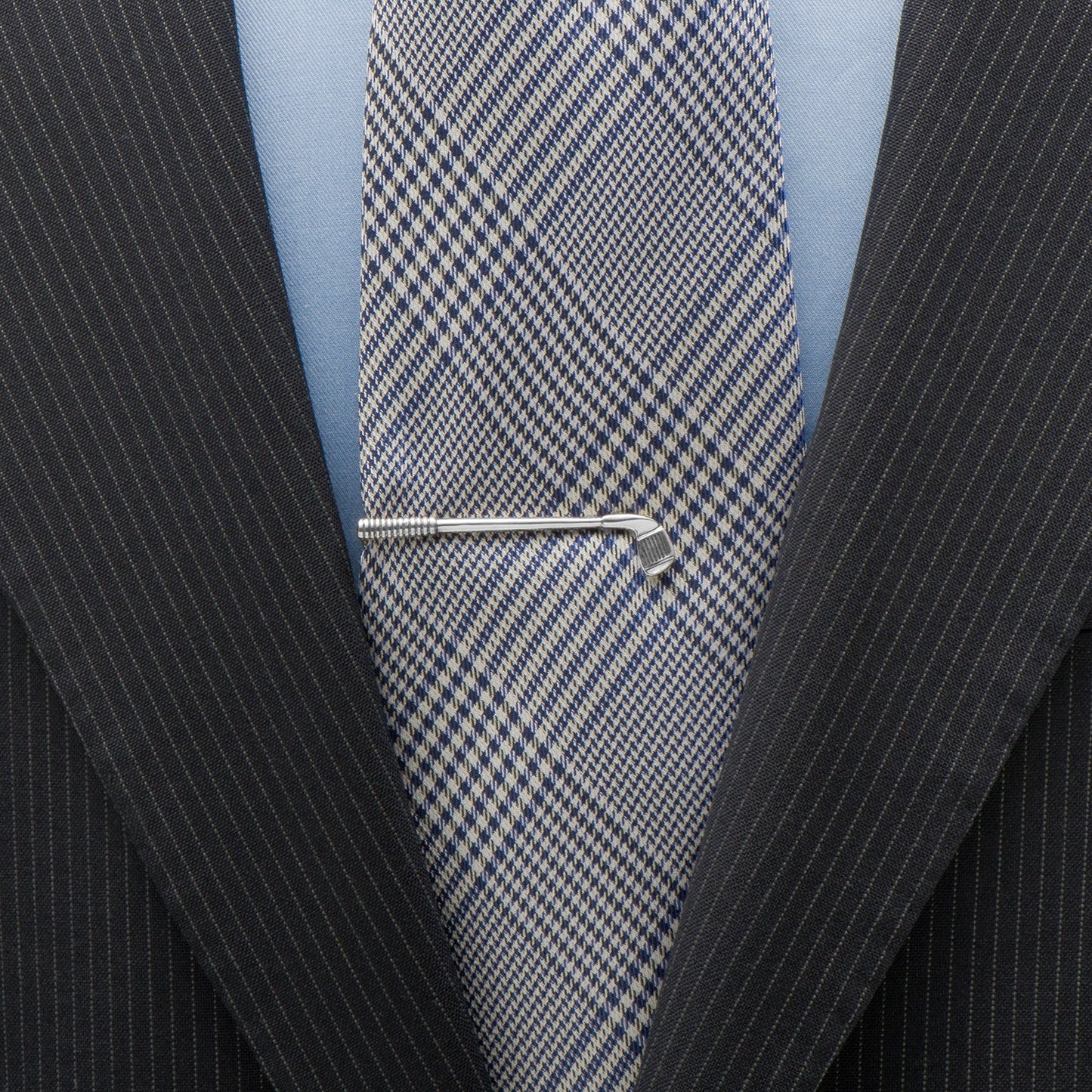 Close-up of a suit with a blue checkered tie and a silver tie clip. Golf Club Tie Clip