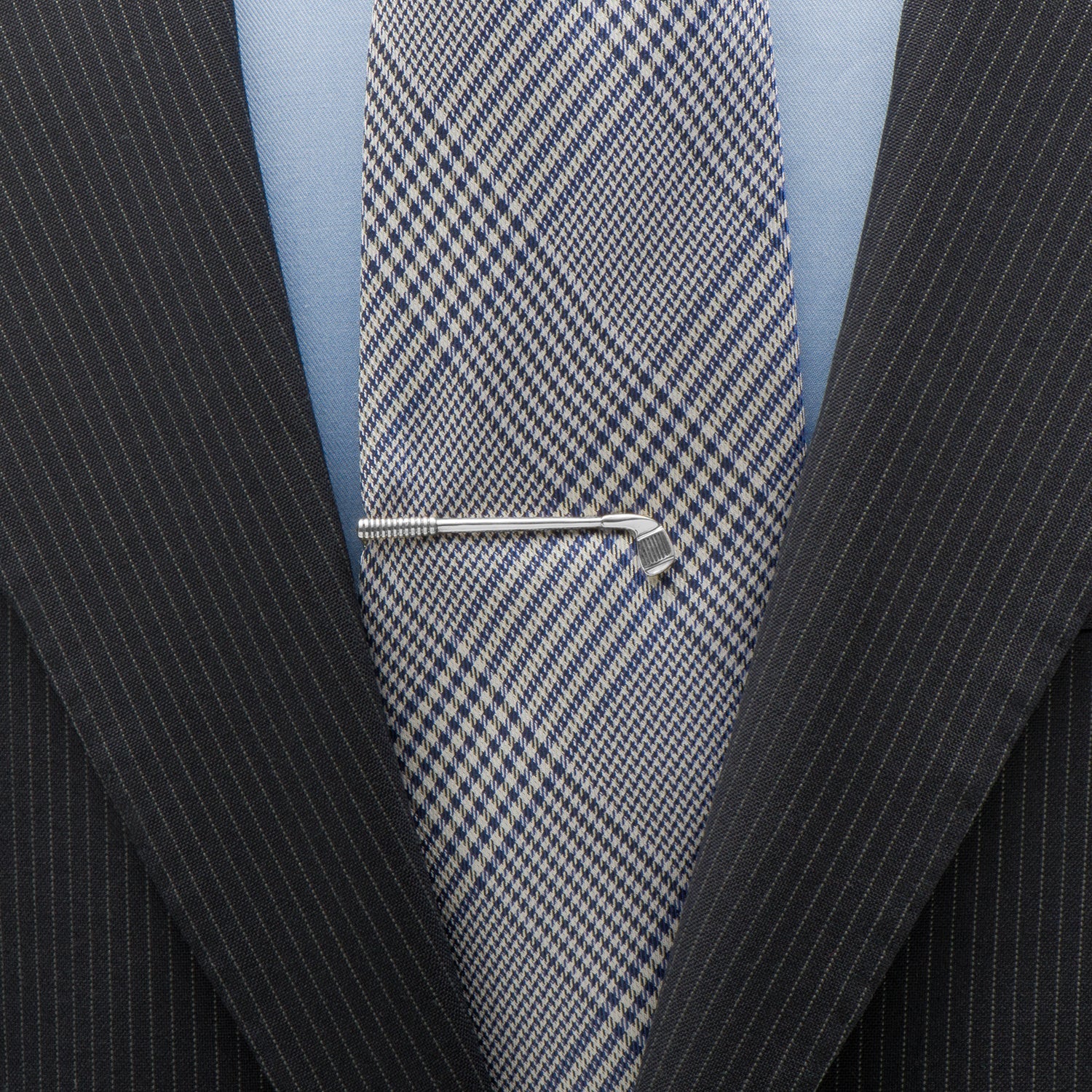 Close-up of a suit with a blue checkered tie and a silver tie clip. Golf Club Tie Clip