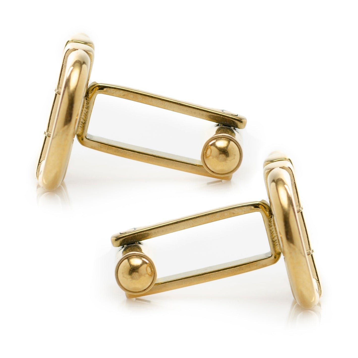 Gold cufflinks on a white background