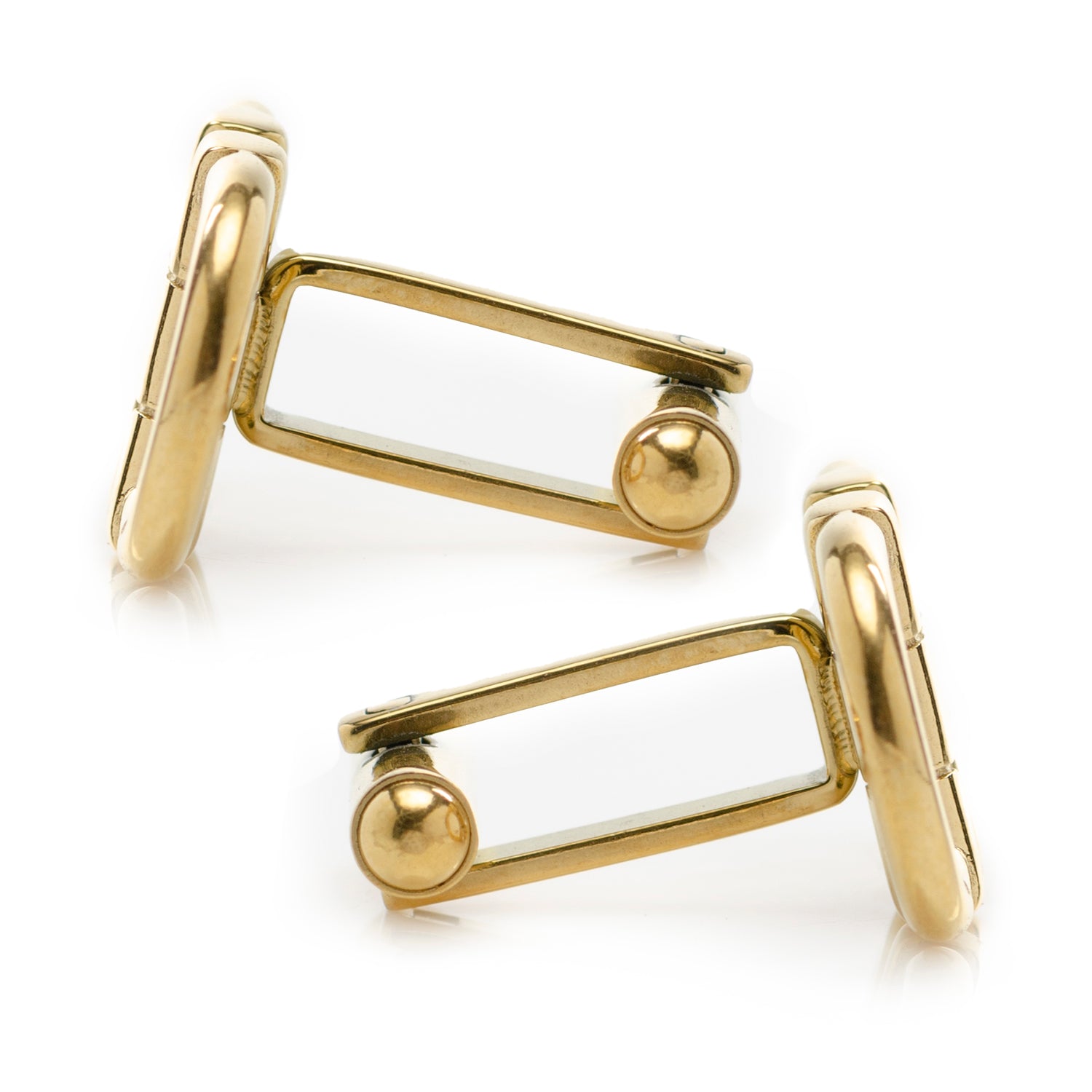 Gold cufflinks on a white background