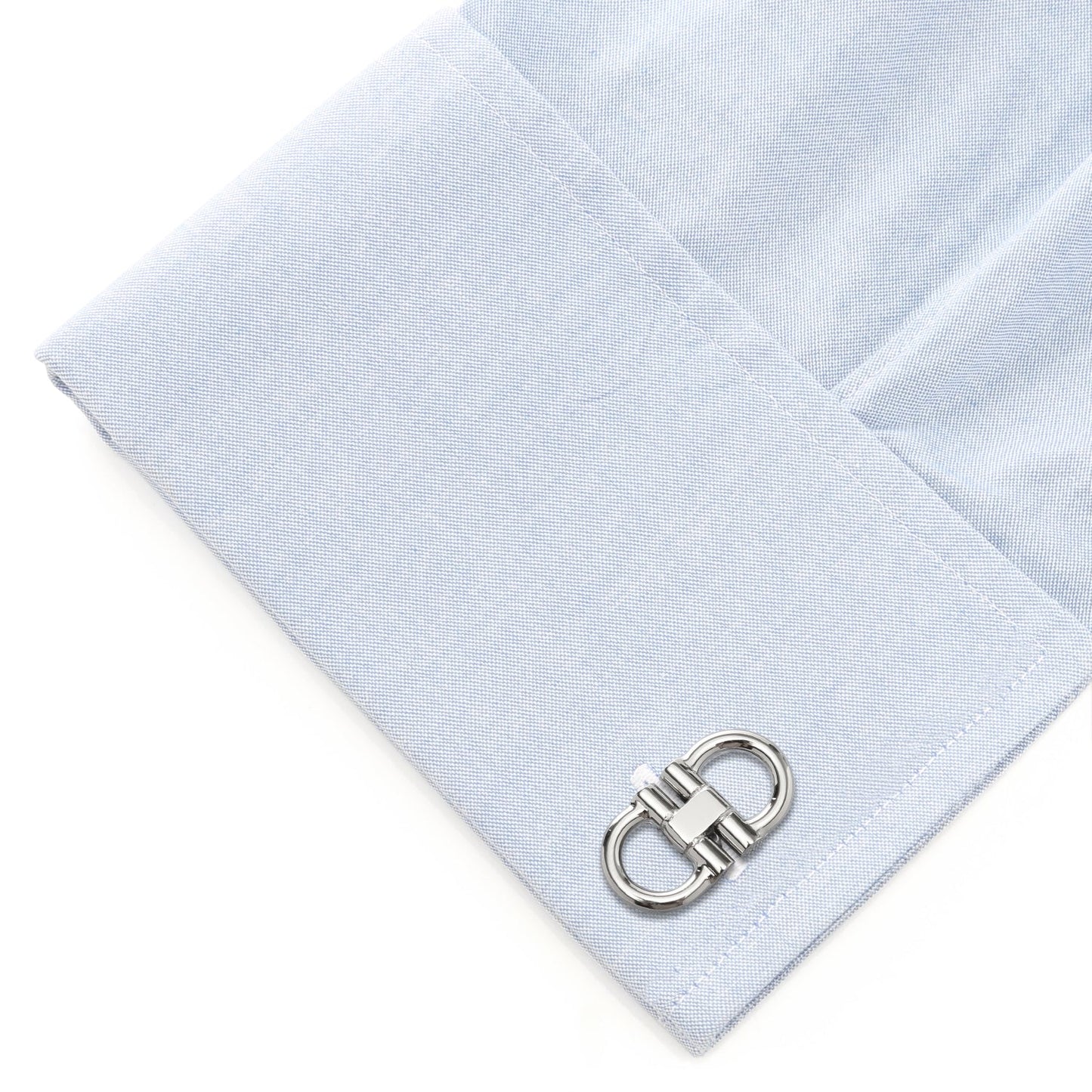 Light blue pocket square with a silver cufflink on a white background