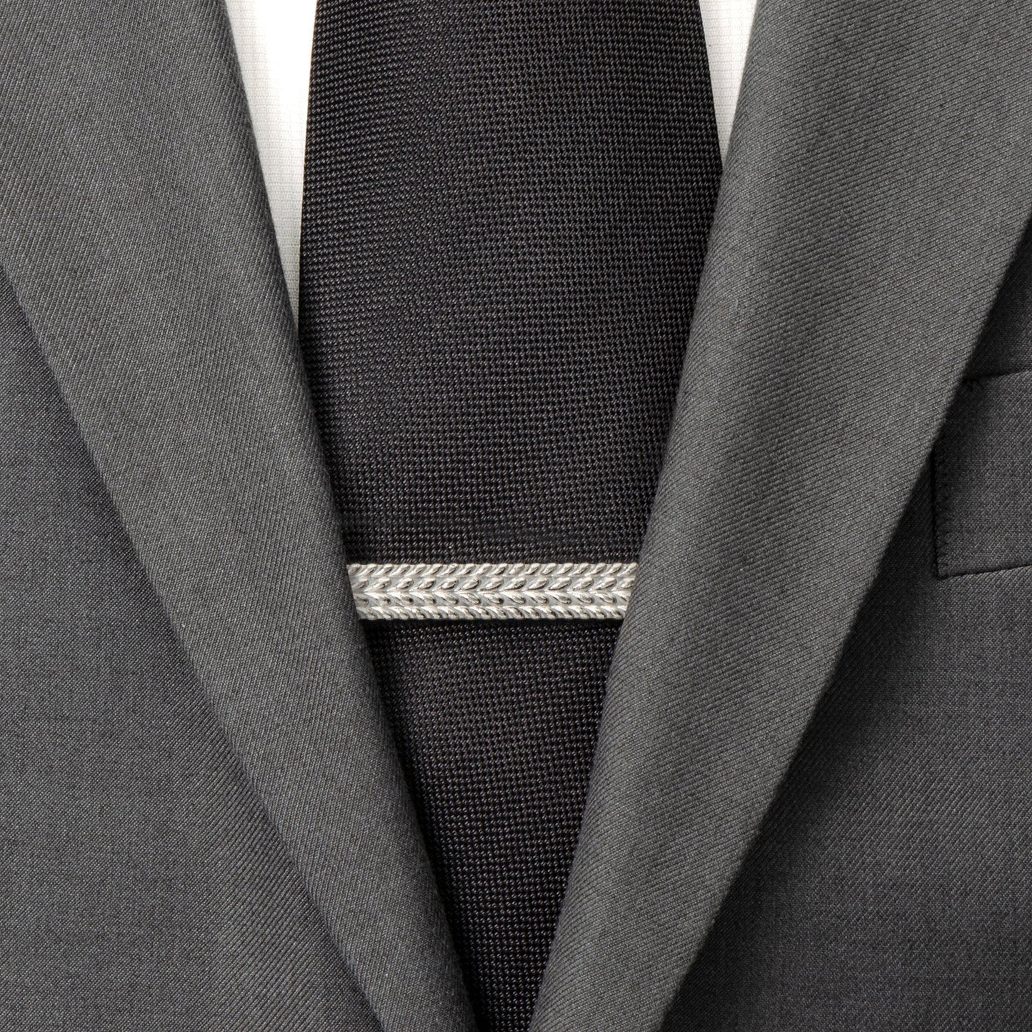 Gray suit jacket with a black tie and silver tie clip on a white background