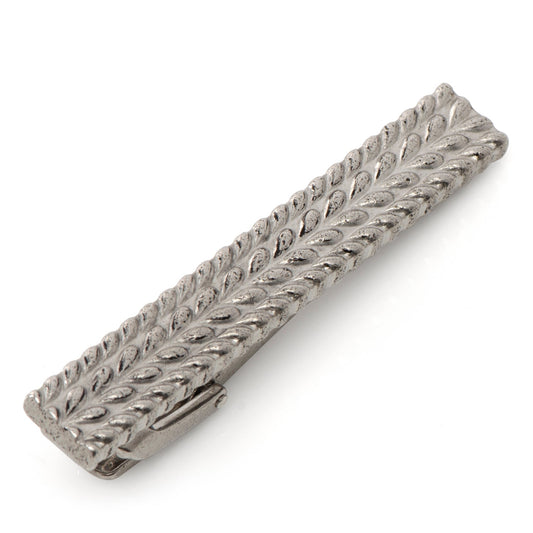 Silver tie clip with intricate design on a white background