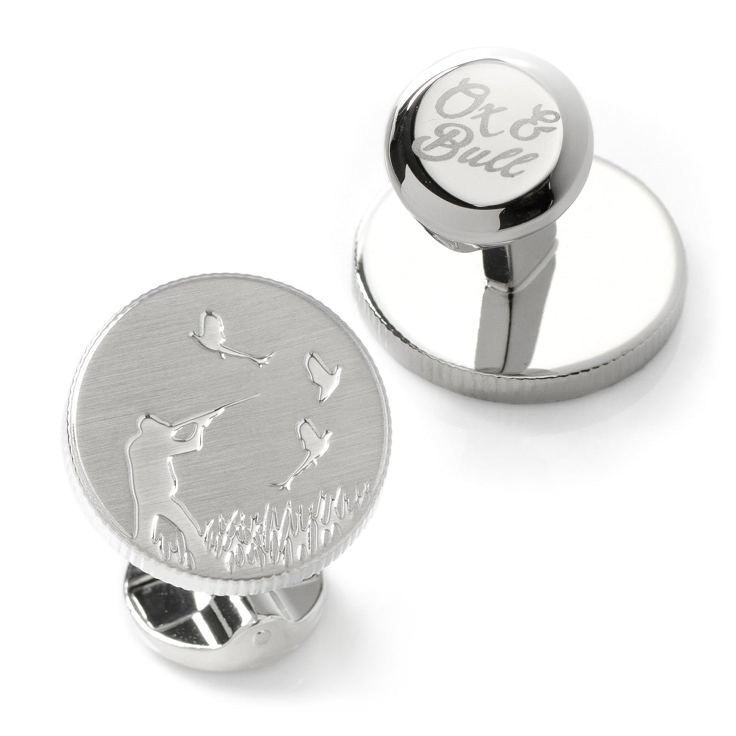 Silver cufflinks with engraved design on a white background