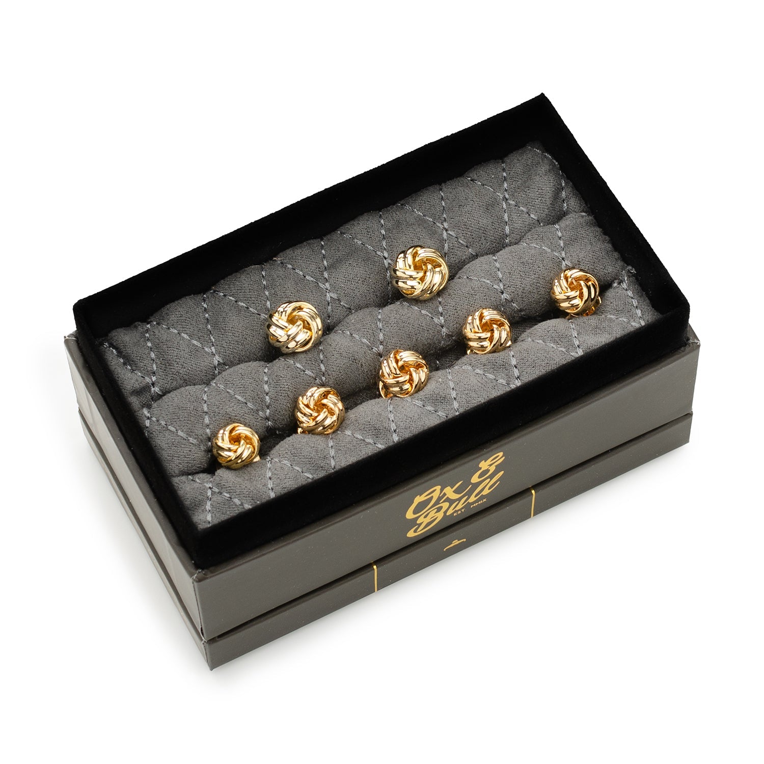 Set of gold cufflinks in a black box with 'Ox & Bull' branding.