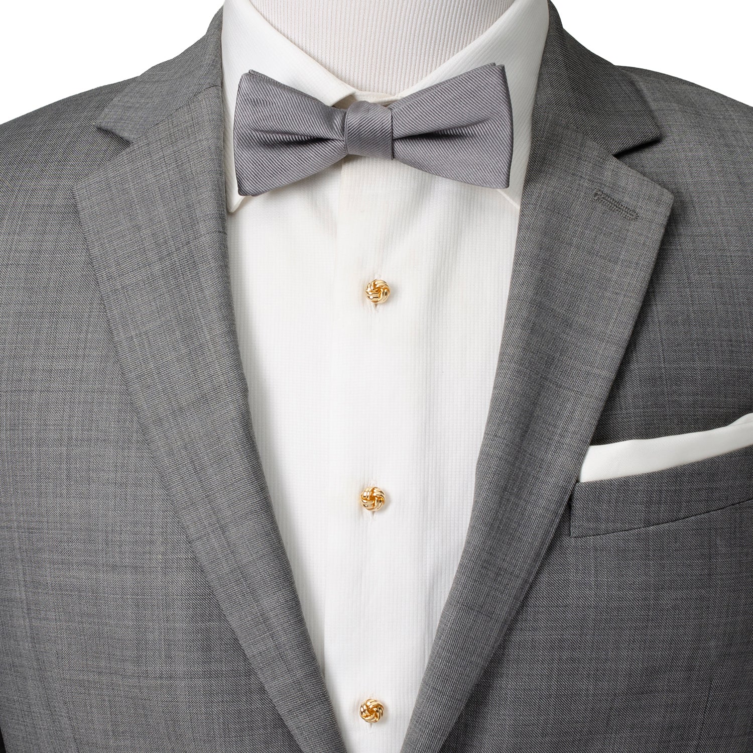 Gray suit jacket with a bow tie and white shirt on a mannequin.