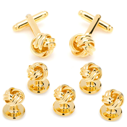 Set of gold knot cufflinks and matching tie clips on a white background