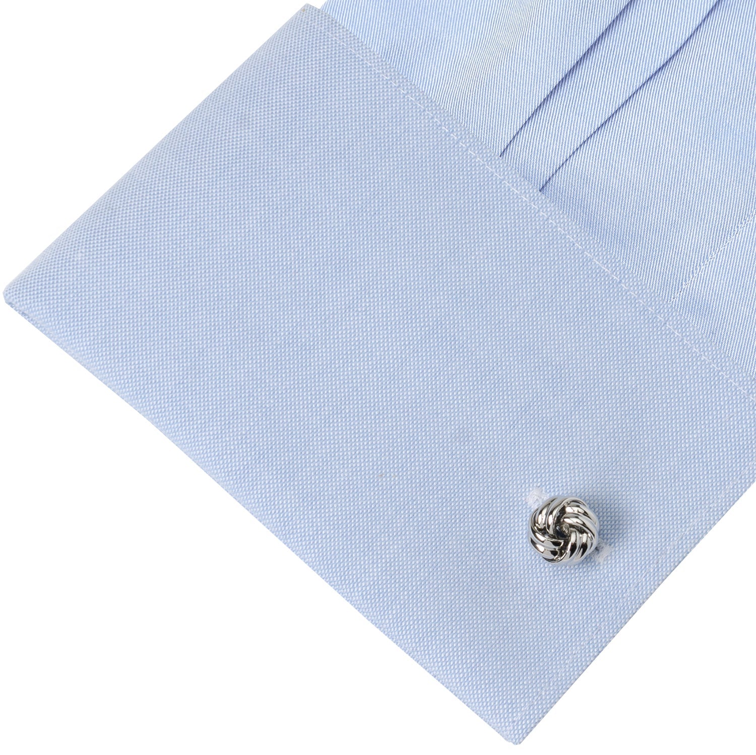 Silver knot cufflink on a light blue dress shirt