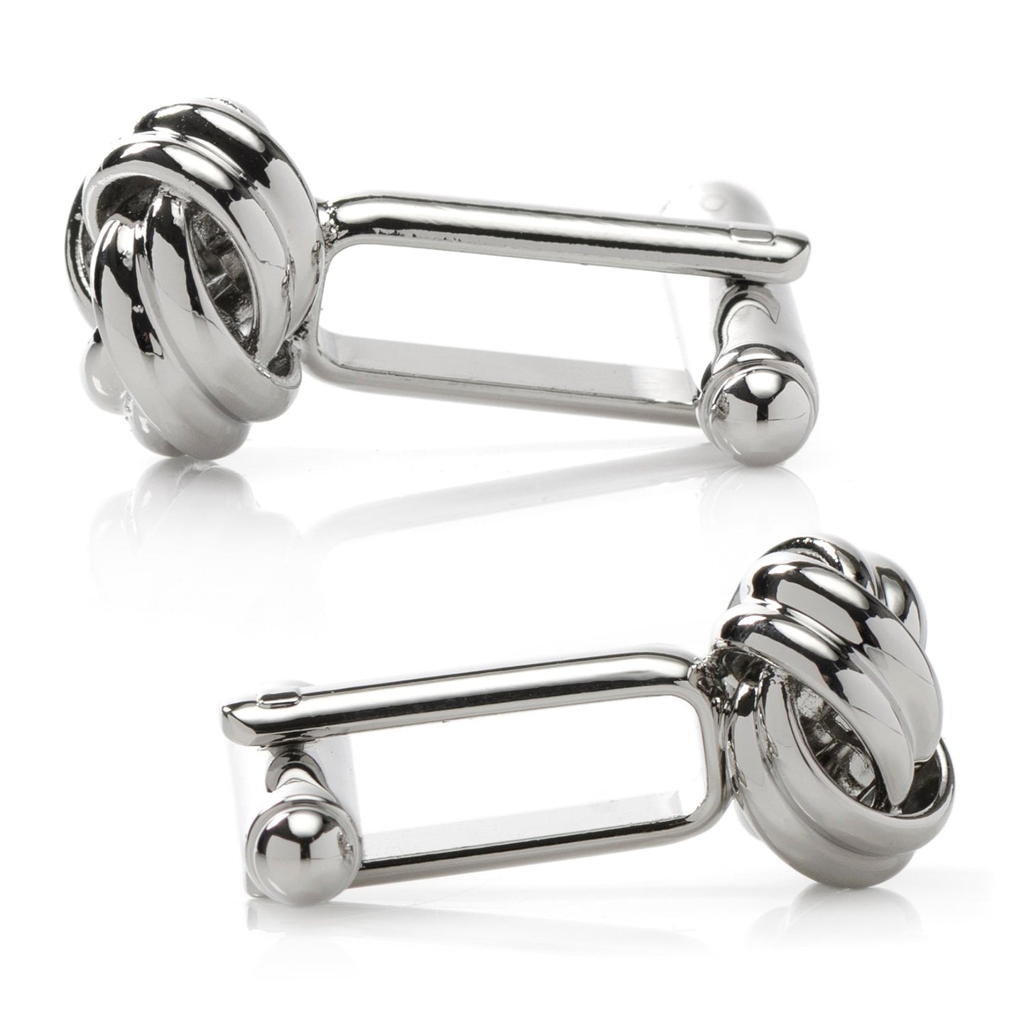 Pair of silver knot cufflinks on a white background