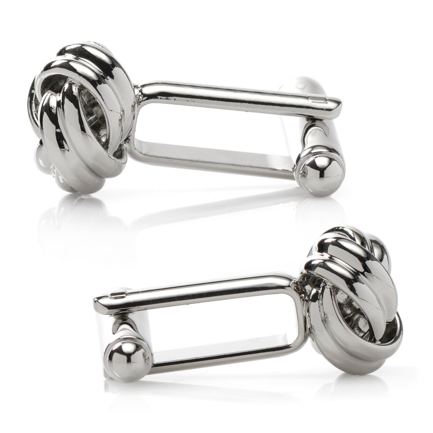 Pair of silver knot cufflinks on a white background