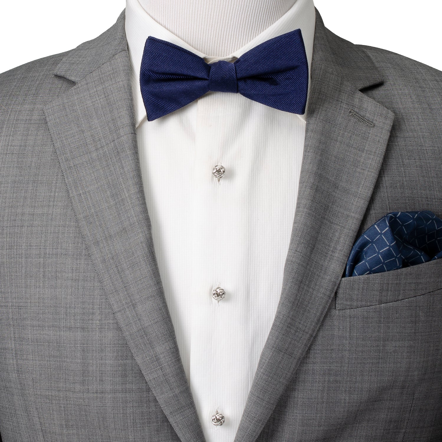 Gray suit with a navy bow tie and pocket square on a mannequin.