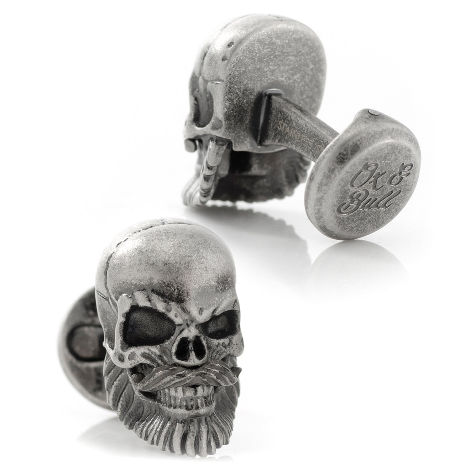 Skull-shaped cufflinks with 'Ok & Bull' engraving on a white background