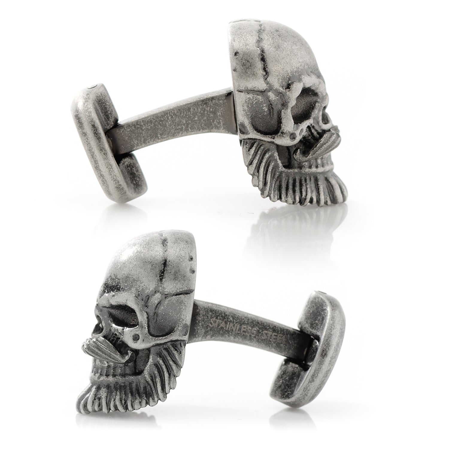 Pair of skull-shaped cufflinks on a white background