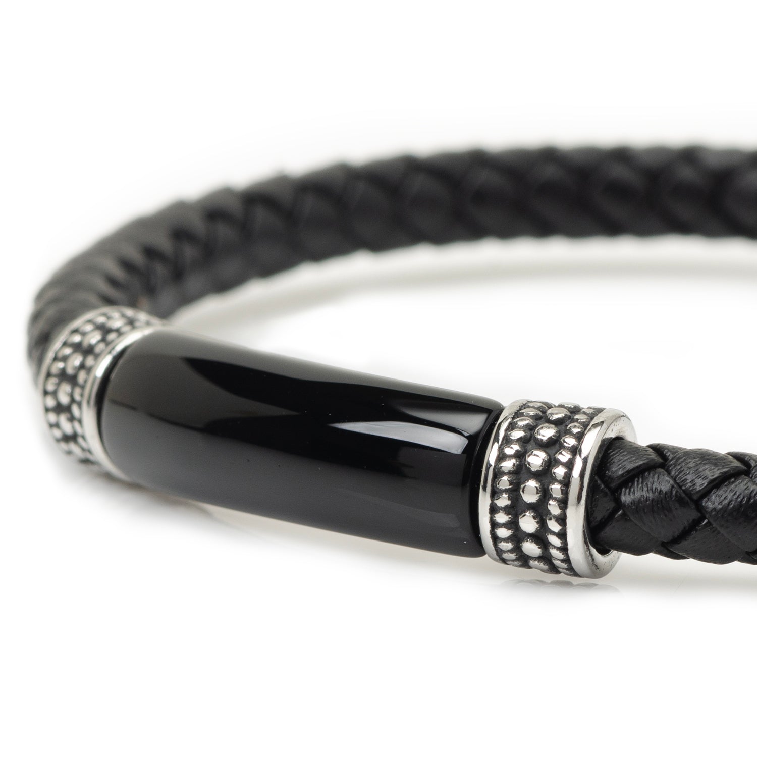 Black braided leather bracelet with a silver and black cylindrical clasp on a white background